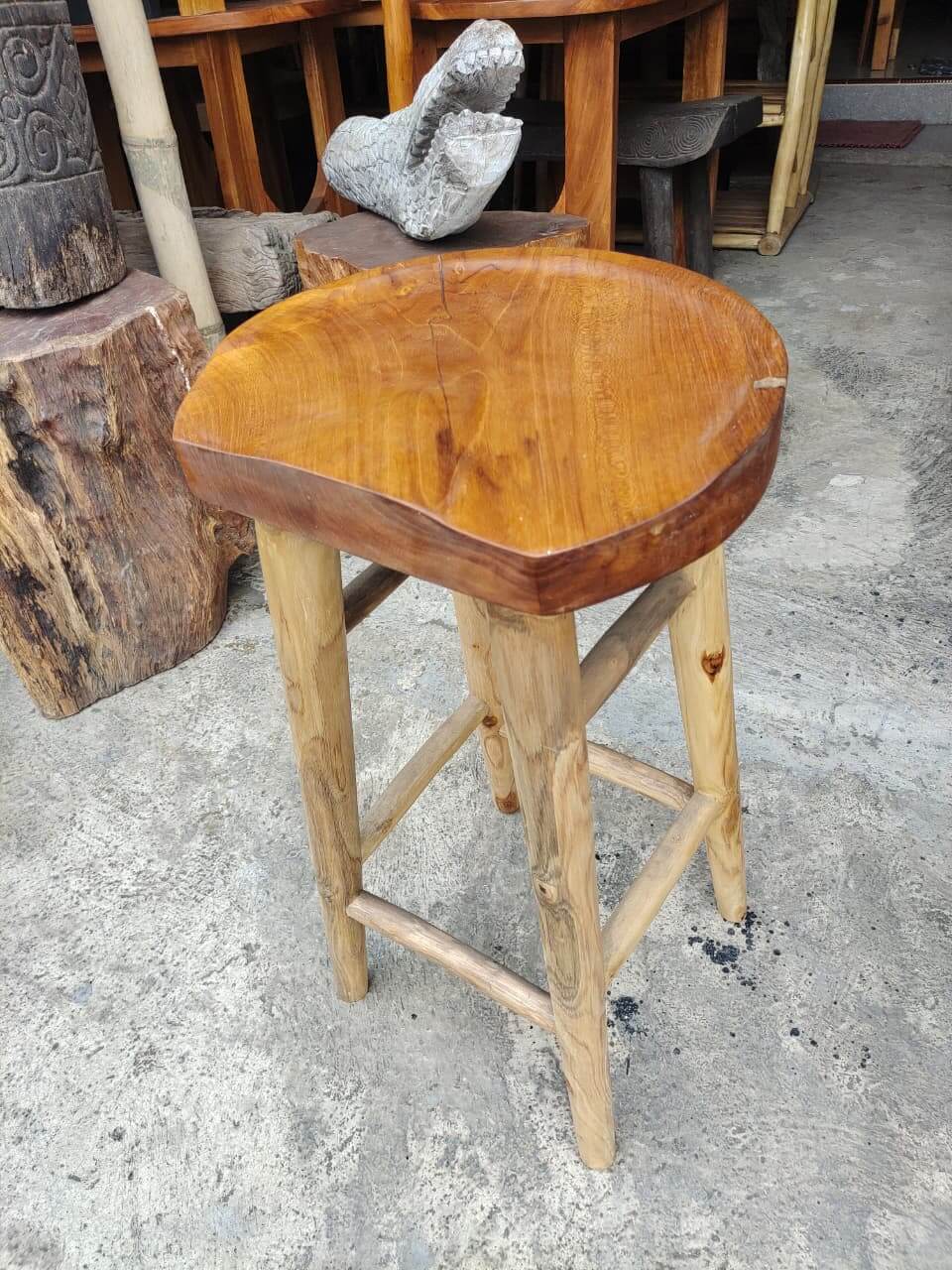 Solid wood bar chair with a natural grain wide seat and sturdy wooden legs.