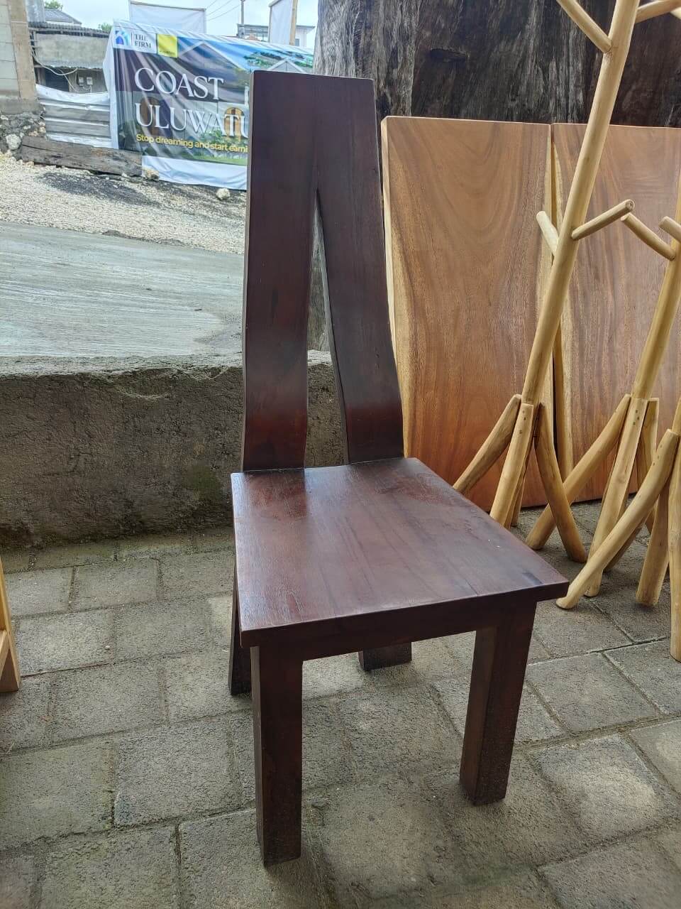 Chairs E solid wood featuring a unique high backrest with a triangular slit and dark brown finish.