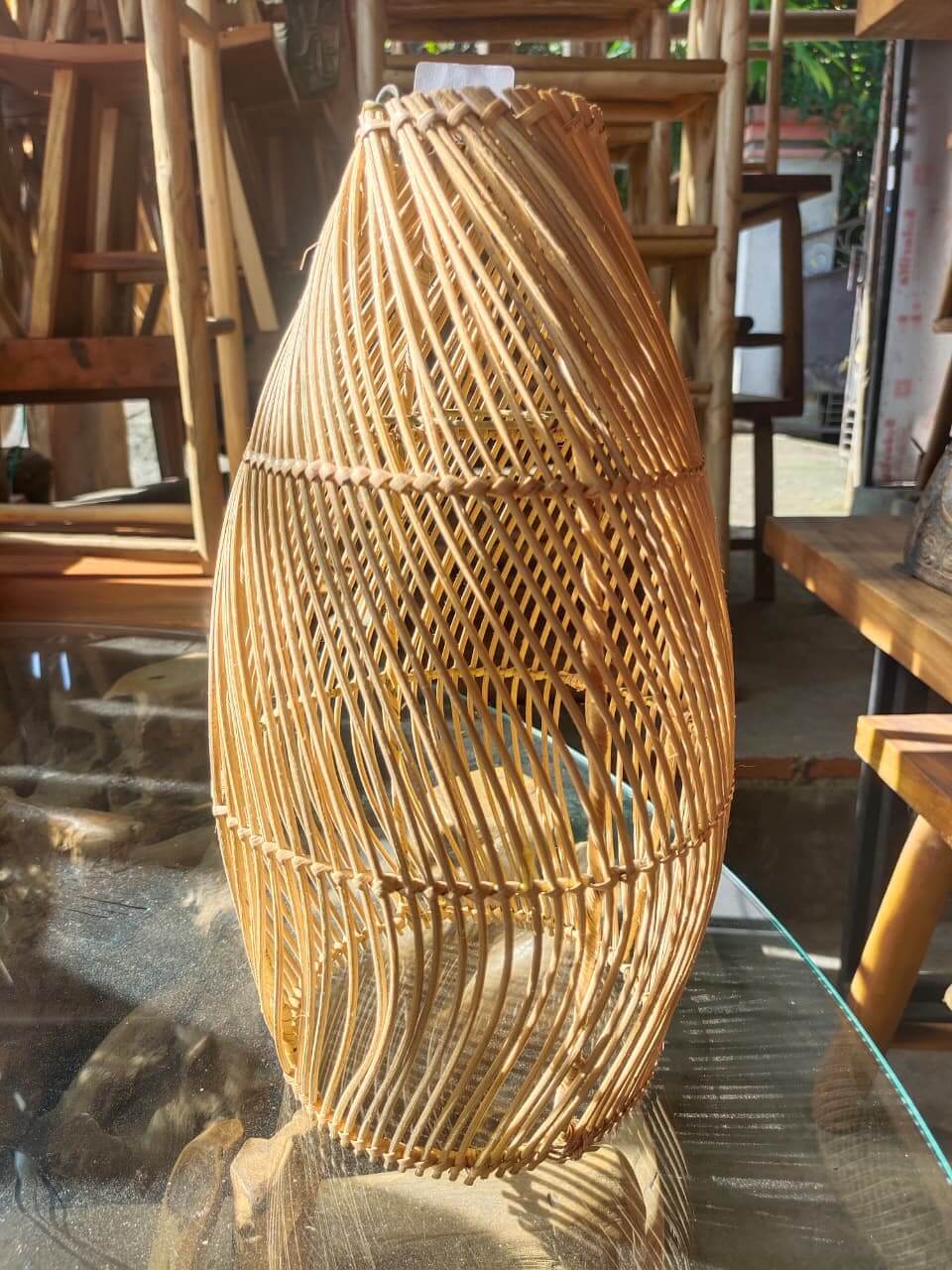 Lampu hias anyaman rotan alami buatan tangan dengan desain anyaman terbuka.