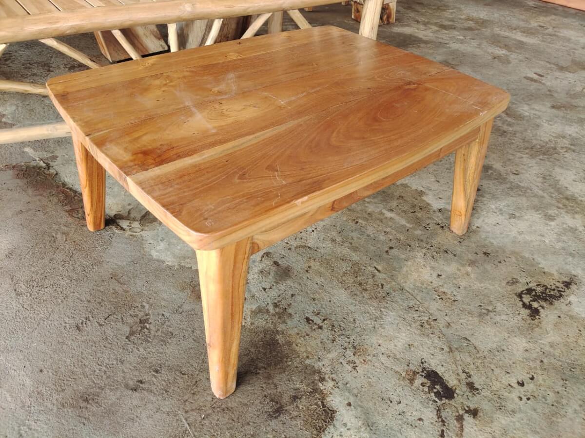 Solid wood coffee table with a thick surface and smooth natural wood grain textures.