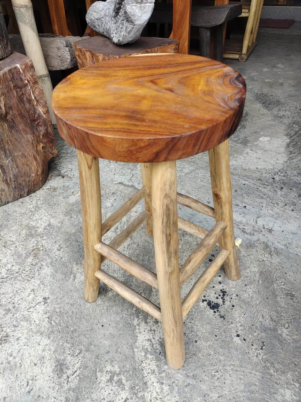 Round wooden bar chair with dark natural grain seat and light wood legs.