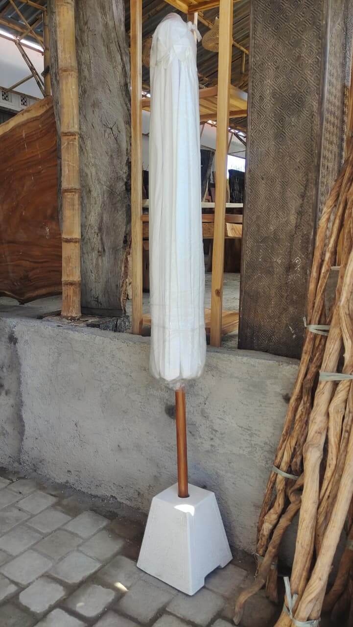 Outdoor garden umbrella with solid wooden pole and white canopy